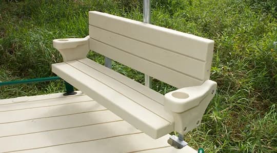 EZ Dock beige polyethylene bench with armrests and cup holders, mounted on a dock deck