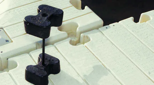 EZ Dock black rubber coupler set joining two tan dock sections, close photo